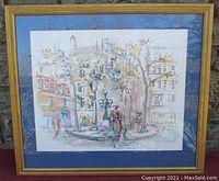 Framed watercolor artwork showing a Paris street scene and figures with a gold frame and blue matting.