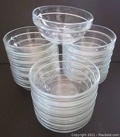 Stack of 18 clear tempered glass prep bowls showing uniform size and shape