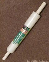 Stretch wrap film roll showing full length, with white core and green label with visible text.