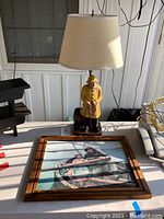 Full view of the ceramic Old Salt lamp and the framed print on a table showing size and relative placement.