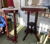 Full view of both marble top tables: vintage rectangular with carved legs and round with gold accent details