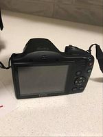 Back view of Canon PowerShot SX400 showing LCD screen and control buttons.