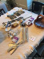 Full overview of assorted kitchen bar utensils and serving items on table