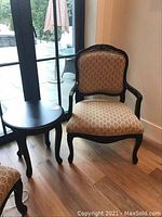 Full view of Louis style chair and matching black round side table