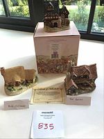 Photo showing all three ceramic cottage figurines with their names and Certificate of Authenticity.