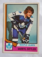 Front side of the 1974-75 Darryl Sittler hockey card featuring player in Toronto Maple Leafs uniform.