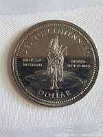 Obverse of the 1983 Fergus Ontario Dollar Coin showing a bagpiper and the expiration date.