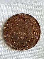 Reverse side of the 1919 Canadian one cent coin showing 'ONE CENT CANADA 1919' with detailed leaf and vine border.