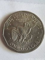 Reverse side showing eagle with partially spread wings and inscriptions UNITED STATES OF AMERICA, E PLURIBUS UNUM, and ONE DOLLAR