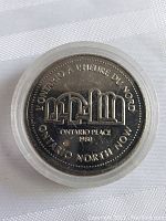 Obverse side of the 1980 Northern Ontario dollar coin showing inscription and logo with 'Ontario Place 1980' text.