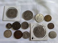 Top view of assorted Canadian coins from various years and materials arranged on a white cloth surface