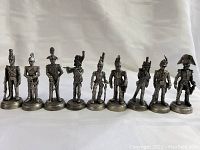 Front view of nine lead pewter Napoleonic War figures showing detailed military uniforms and soldier poses