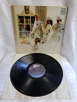 Front cover of Cheap Trick Dream Police vinyl LP along with the vinyl record lying flat.