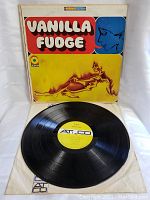 Vinyl LP record with original Atco yellow label placed over album cover and protective sleeve underneath.