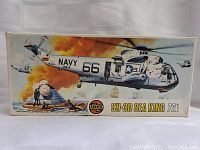 Front of the Airfix Sea King helicopter model kit box showing the illustrated image of the helicopter in a rescue scene with fire and smoke in the background, marked NAVY 66 HS-4.