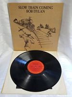 Front of album cover showing illustrated cover art with train and man striking railroad tracks