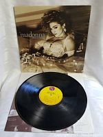 Full view of the Madonna Like A Virgin album cover with record displayed on a white background.