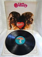 Photo showing vinyl record with sleeve open, vinyl in good condition with colorful label and visible grooves.