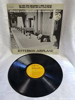 Front cover and vinyl LP of Jefferson Airplane Bless Its Pointed Little Head album, showing yellow RCA label on record and cover photo.
