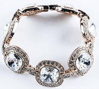 Top view of the bracelet showing all 7 cushion cut Swarovski elements set in gold plated bezels with bead settings.