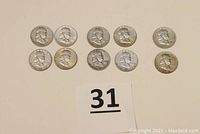 Ten Franklin half-dollar coins arranged in two rows showing obverse (Benjamin Franklin bust)