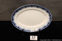 Full front view of the large oval blue and white platter with intricate border pattern
