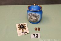 Lot display showing the antique Masonic commemorative jar, four stamped pennies, and new Knights Templar emblem