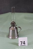 Full view of the Wallace pewter finger kerosene lamp with cosmos burner and glass chimney