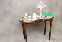 Front and side view of the vintage wooden dressing table with glass top and various accessories arranged on it