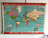 Full view of the vintage world map showing continents and promotional branding for Neilson's Jersey Milk chocolates.