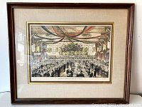 Full view of framed antique print showing the banquet scene with matting and wooden frame.