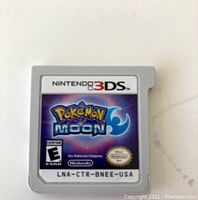 Front view of Nintendo 3DS Pokémon Moon game cartridge with label showing game title and logos.