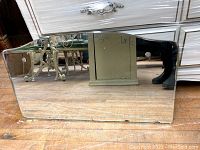 Full front view of the rectangular beveled mirror showing overall shape and wear.