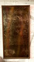 Front view of large rectangular framed glass panel with brown and gold textured pattern and wooden frame.
