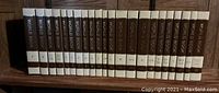 Photo of World Book Encyclopedia volumes from A to Z with cream and brown spines.