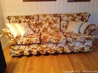 Front view of the three-seat sofa with floral fabric and cushions