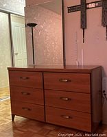 Front view of 1950s solid wood dresser with six drawers and large rectangular mirror attached horizontally.