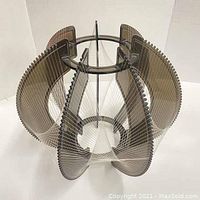 Front perspective showing full geometric shape with smoke-colored acrylic panels and white string pattern