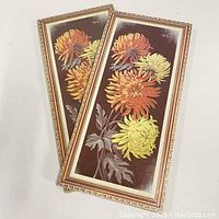 Two vintage floral cork prints with chrysanthemum designs, one still sealed. Prints mounted on thick boards with decorative printed frame.