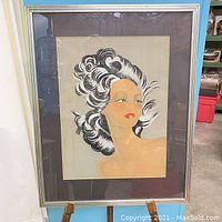 Full view of framed forties style female portrait print, silver-tone frame, glass over print