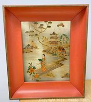 Front view showing painted Asian scene with woman, flowers, buildings, and trees inside a reddish-orange framed light box.
