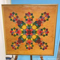 Full front view of the framed wooden art piece showing the colorful checkerboard geometric pattern.