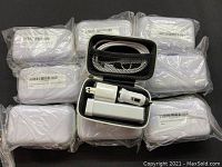Ten white power banks in individual zippered carrying cases, all packaged in plastic wrap.