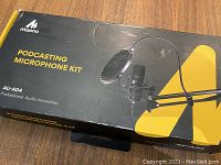 Closed box of Maono Podcasting Microphone Kit AU-A04 showing product branding and image.