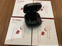 Four boxes of Bottune True Wireless Stereo Earbuds stacked, one open charging case with earbuds visible.