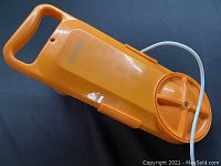 Full view of orange Kotanorm portable washing machine showing handle and round knob