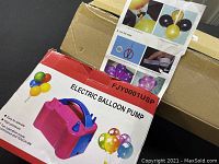 Electric balloon pump box with colorful balloon graphics and product name.