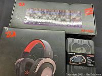 Lot items in original packaging showing Redragon Kumara keyboard box, headphones box, and mouse box.