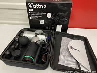 Wattne W2 massage gun with multiple detachable massage heads and carrying case displayed with box