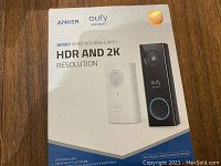 Box packaging showing Anker Eufy Wired Video Doorbell with HDR and 2K Resolution, highlighting key features and branding.